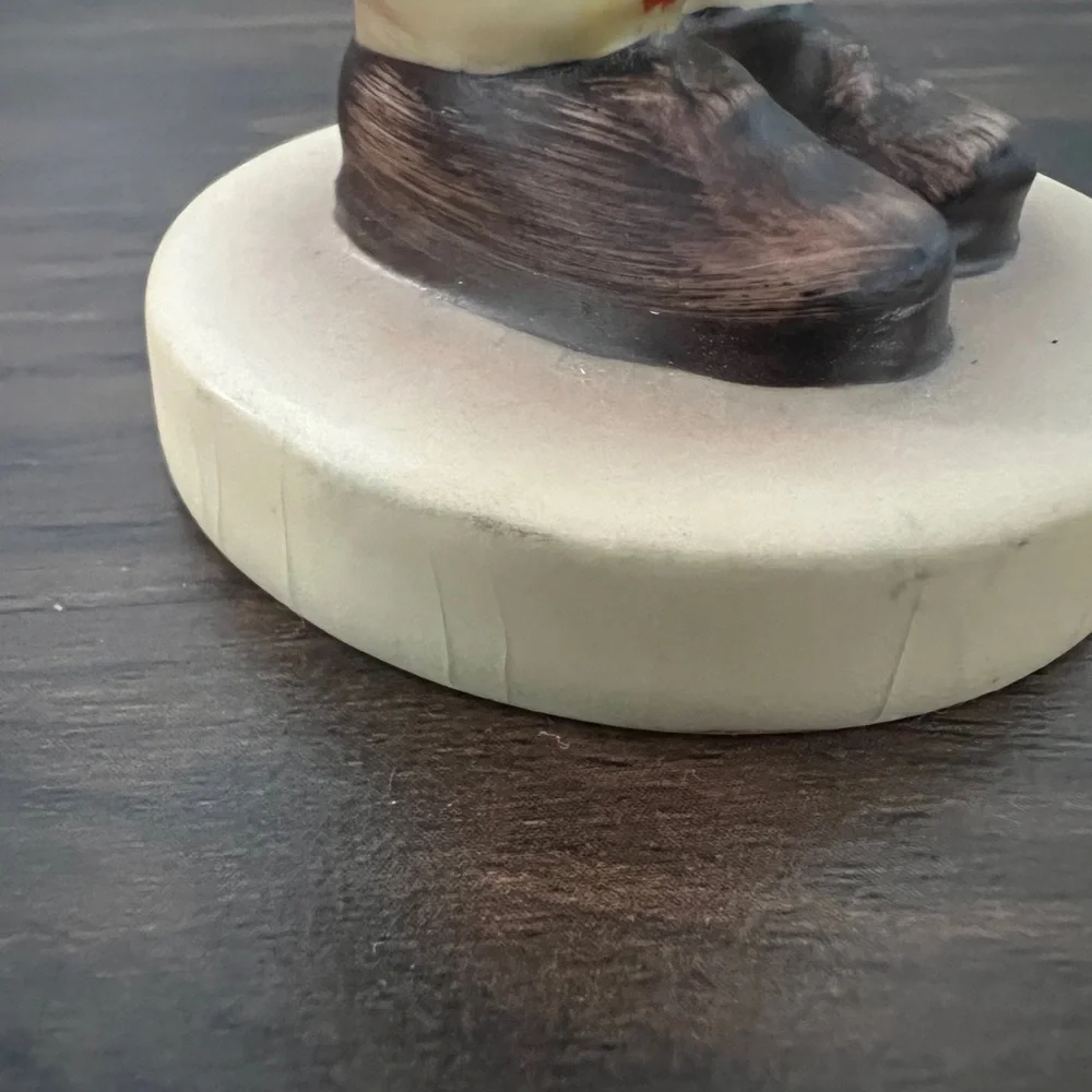 Charming Figurine with Purple and Brown Accents